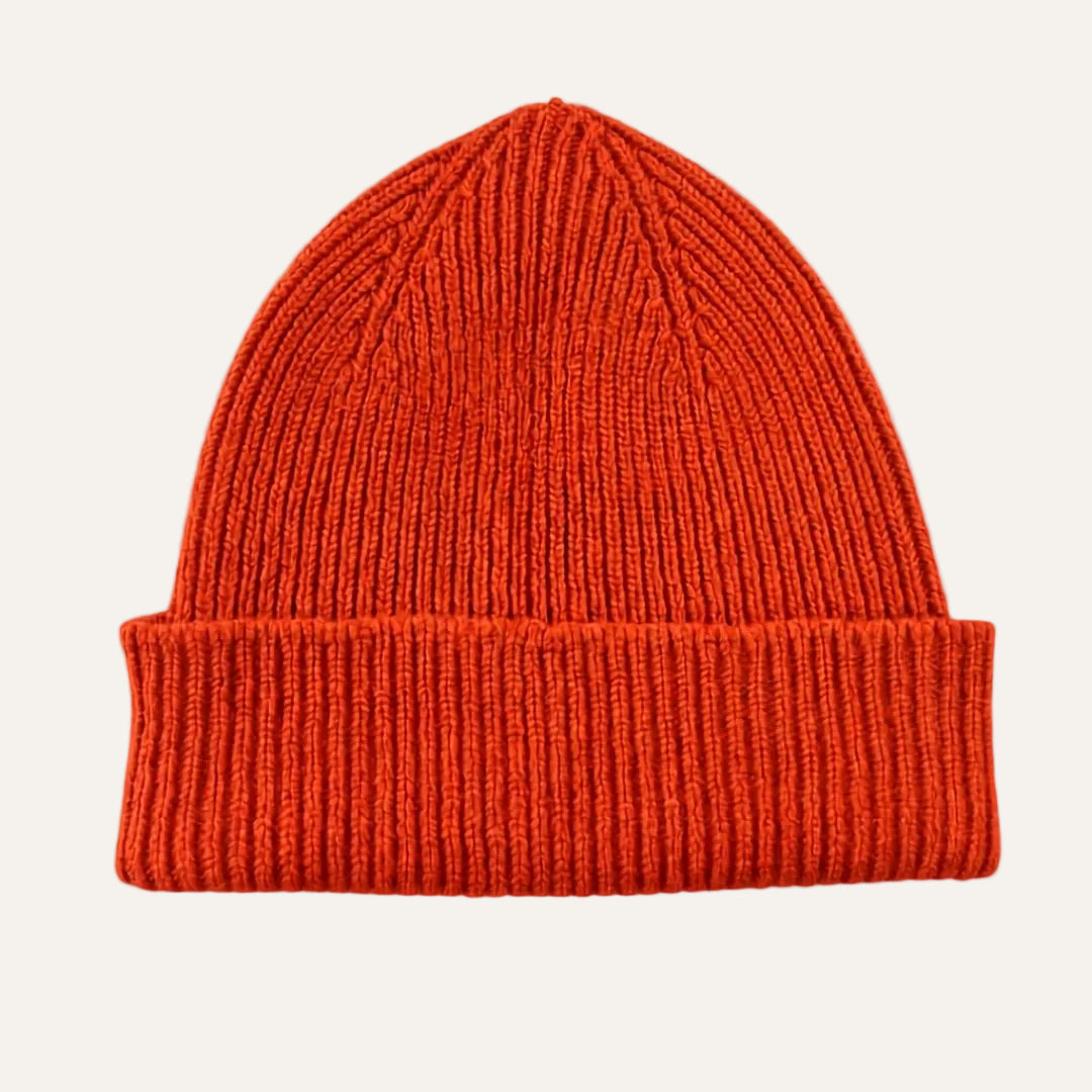 A bright orange ribbed knit beanie hat with a folded cuff, shown against a plain white background.