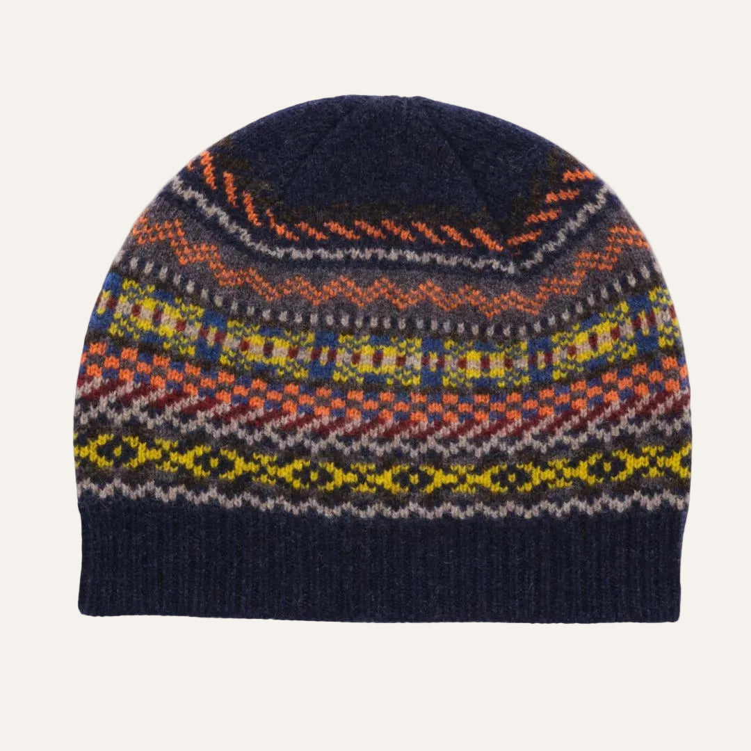 A multicolor Fair Isle knit beanie hat with a dark navy blue base and horizontal bands of orange, yellow, green, and white geometric patterns, shown on a plain white background.