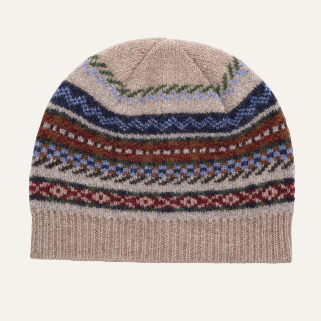 A knit beanie hat with a beige base and multiple horizontal Fair Isle style pattern bands in navy blue, rust red, light blue, and green, shown against a plain white background.