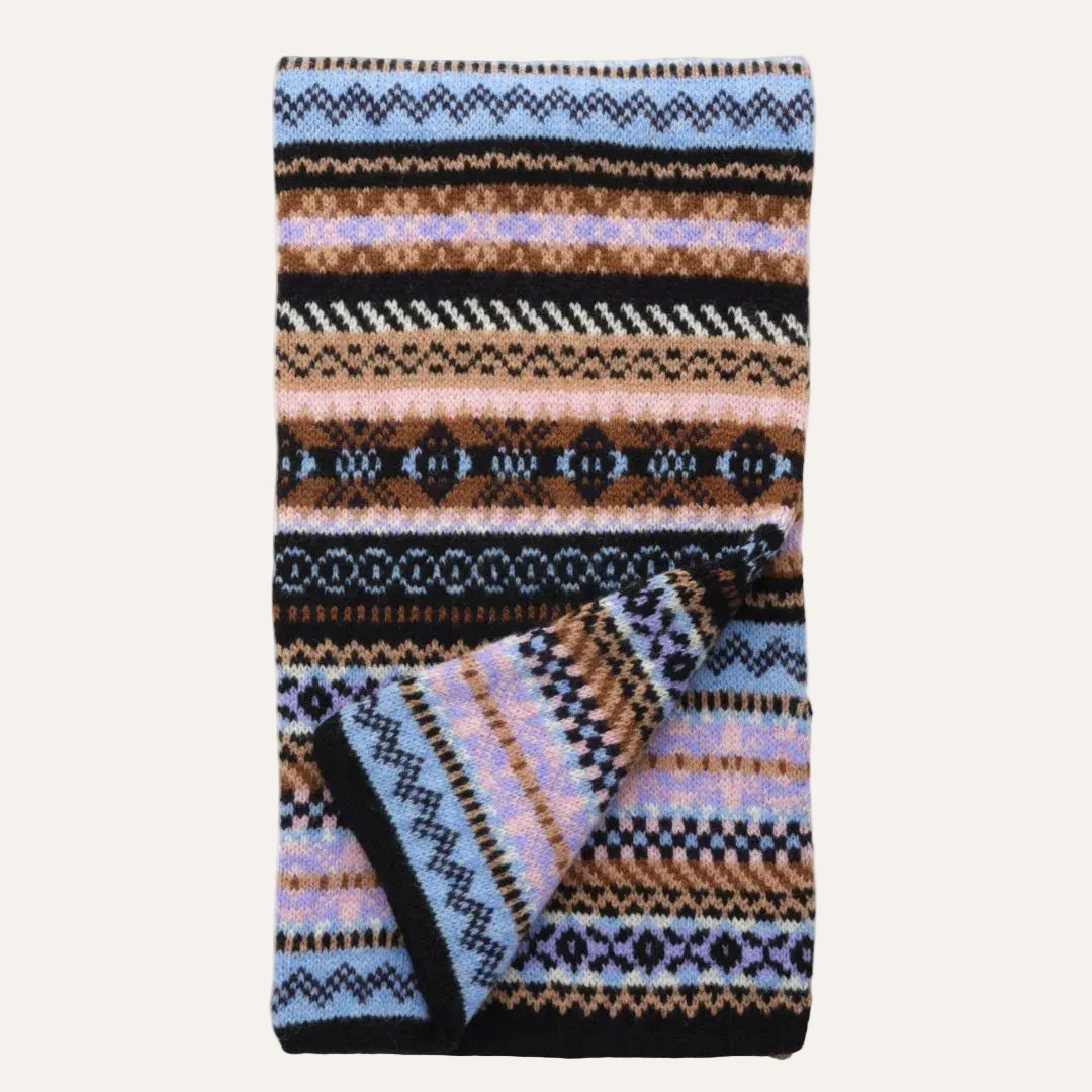 A knit scarf featuring a multicolor Fair Isle pattern with stripes of black, brown, light blue, pink, and cream, shown against a plain white background.