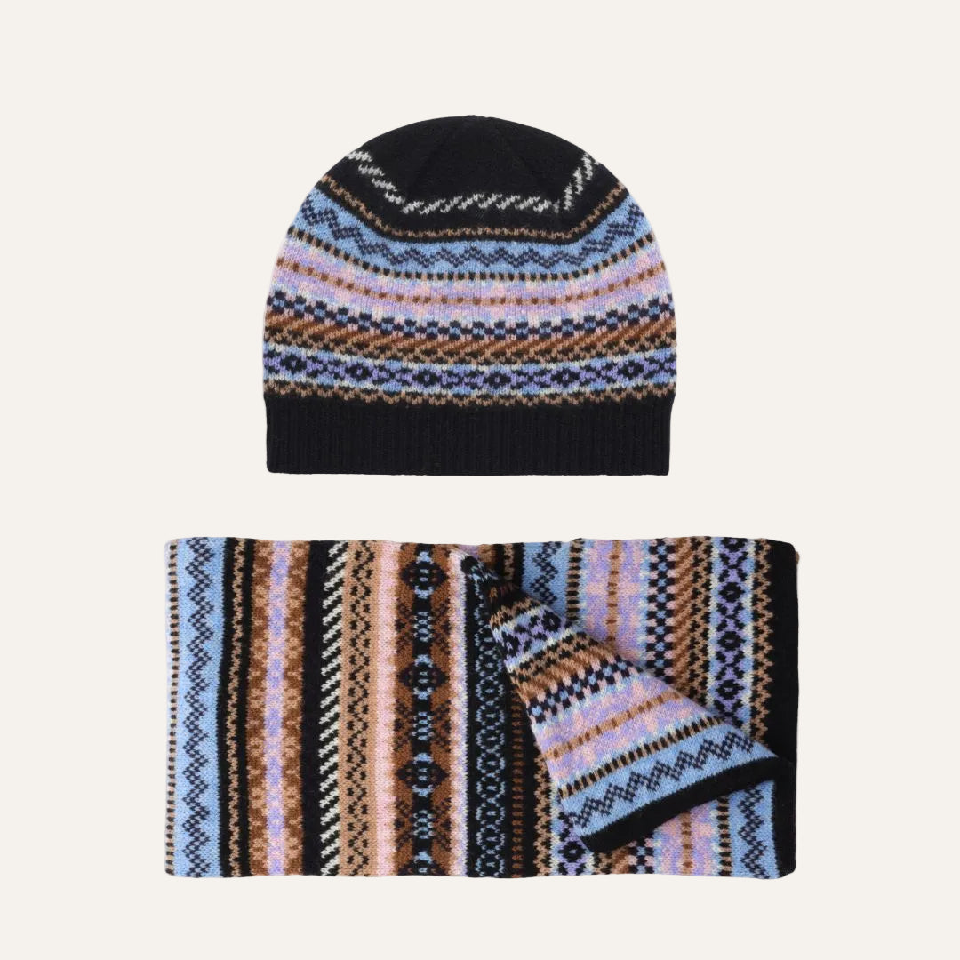 Lambswool knit beanie and matching scarf set with a multicolor Fair Isle pattern featuring black, blue, pink, and brown stripes, shown on a plain white background.