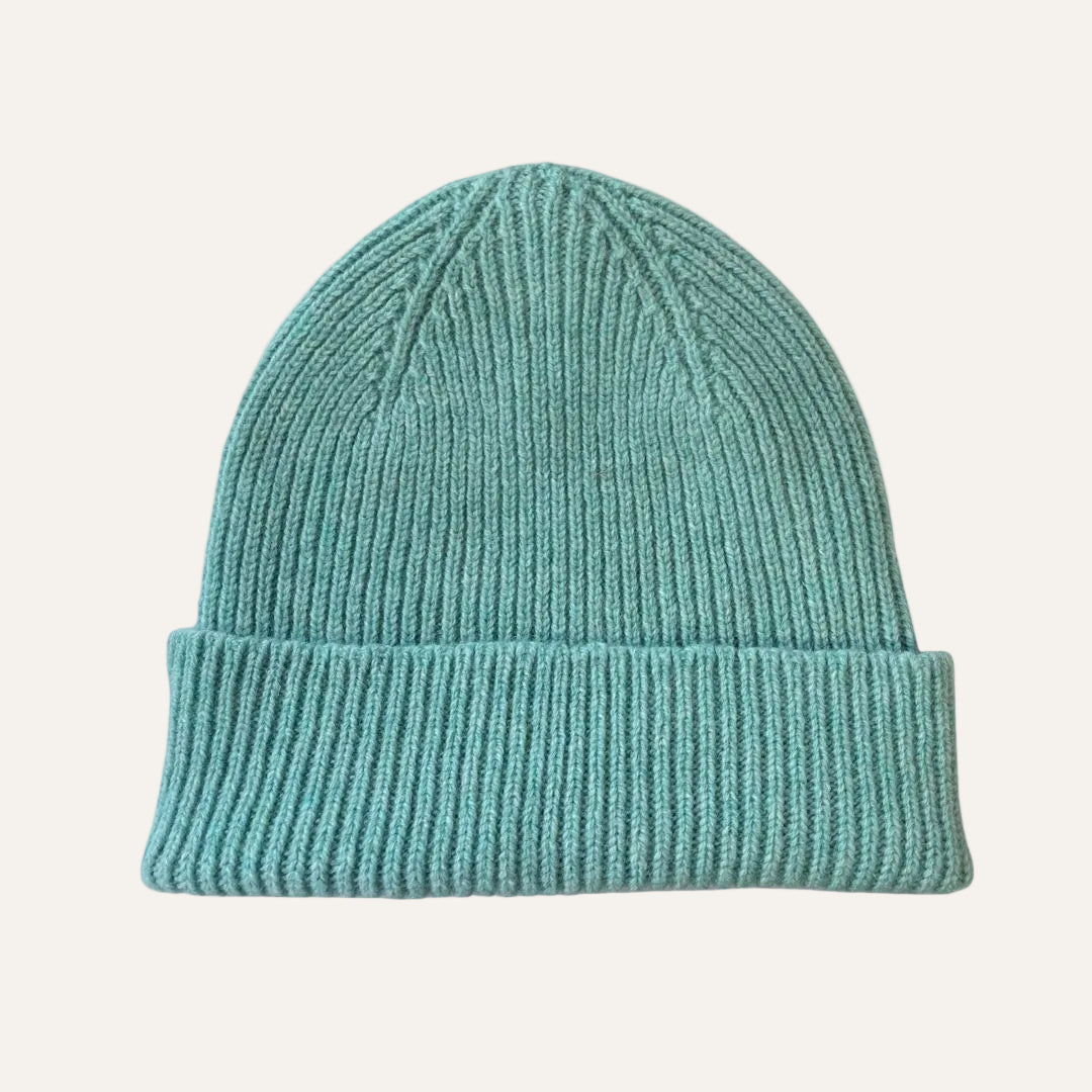 A ribbed knit beanie hat in a jade green color, shown against a plain white background.